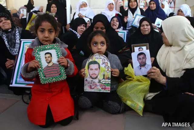 Palestinians women hold pictures of their prisoned relatives in Israeli jails as they gather in a weekly activity calling for their liberty at the Red Cross headquarters in Gaza City on Marsh 28, 2011. About 7000 prisone...