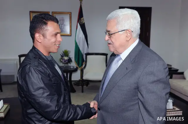 Palestinian President Mahmoud Abbas (Abu Mazen) during a meeting the liberated prisoner, Khalid Abu kamleh in the West Bank city of Ramallah on March 28, 2011. Photo by Thaer Ganaim