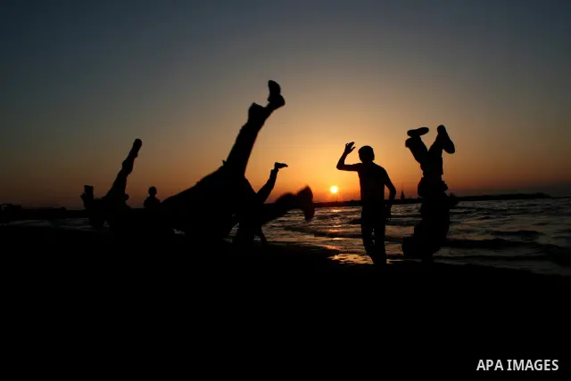 Palestinian youths practice jumping on the beach in Gaza City, on March 28, 2011 as they enjoy their free time. Photo by Mahmoud Nassar
