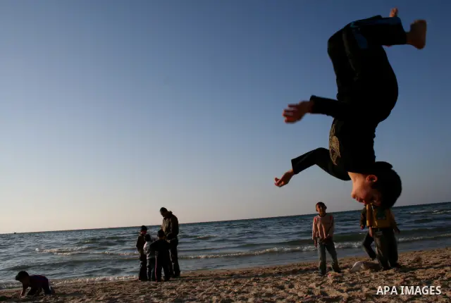 Palestinian youths practice jumping on the beach in Gaza City, on March 28, 2011 as they enjoy their free time. Photo by Mahmoud Nassar