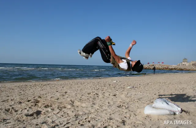 Palestinian youths practice jumping on the beach in Gaza City, on March 28, 2011 as they enjoy their free time. Photo by Mahmoud Nassar