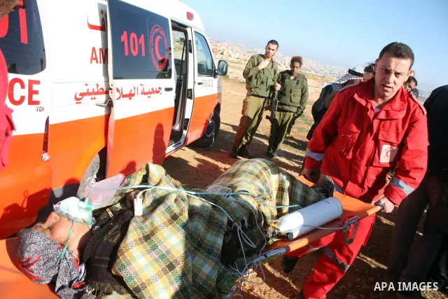 Palestinian medics treat a woman after her home was destroyed allegedly by Israeli army tractors early on 29 March 2011 in the West Bank village of Yatta near Hebron. The house was located in the so-called Area C, a clos...