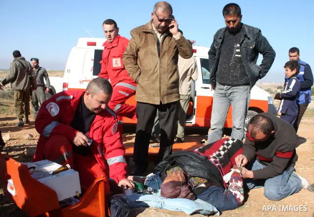 Palestinian medics treat a woman after her home was destroyed allegedly by Israeli army tractors early on 29 March 2011 in the West Bank village of Yatta near Hebron. The house was located in the so-called Area C, a clos...