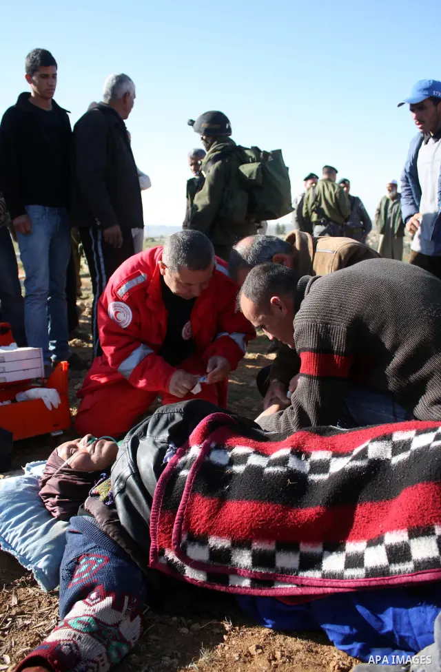 Palestinian medics treat a woman after her home was destroyed allegedly by Israeli army tractors early on 29 March 2011 in the West Bank village of Yatta near Hebron. The house was located in the so-called Area C, a clos...