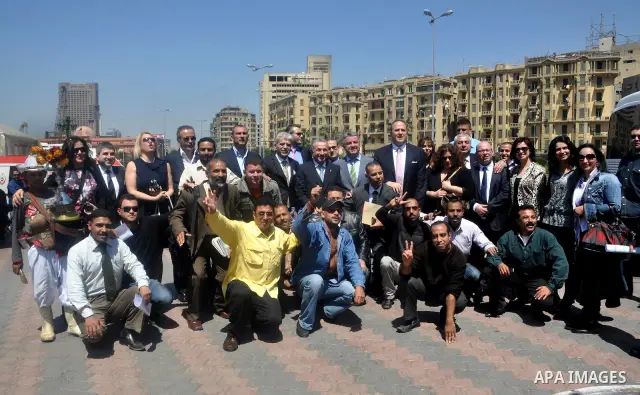Tourists take memorial photos on March 29,2011 at the downtown Cairo's Tahrir square, the giant traffic-clogged roundabout, which hundreds of thousands of Egyptians turned into the focus of their uprising to bring down H...