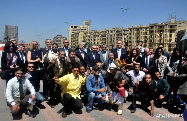 Tourists take memorial photos on March 29,2011 at the downtown Cairo's Tahrir square, the giant traffic-clogged roundabout, which hundreds of thousands of Egyptians turned into the focus of their uprising to bring down H...