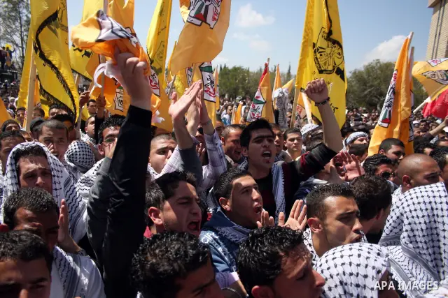 Palestinian students and Fatah supporters who loyal to the Palestinian President Mahmoud Abbas take part in Birzeit University Student Council elections campaign at the Birzeit University, in the West Bank city of Ramall...