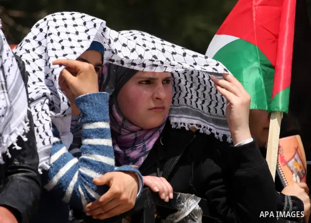 Palestinian students and Fatah supporters who loyal to the Palestinian President Mahmoud Abbas take part in Birzeit University Student Council elections campaign at the Birzeit University, in the West Bank city of Ramall...
