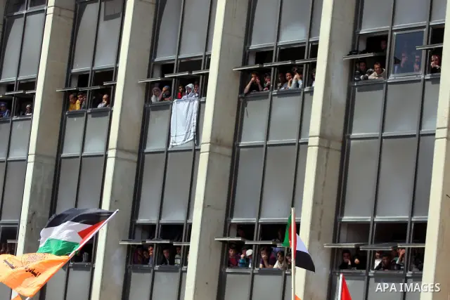 Palestinian students and Fatah supporters who loyal to the Palestinian President Mahmoud Abbas take part in Birzeit University Student Council elections campaign at the Birzeit University, in the West Bank city of Ramall...