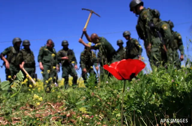 Palestinian security officers plant trees during an event marking Land Day, near the West Bank city of Nablus, Wednesday, March 30, 2011. Land Day commemorates the killing of six Arab citizens of Israel by the Israelis o...