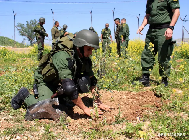 Palestinian security officers plant trees during an event marking Land Day, near the West Bank city of Nablus, Wednesday, March 30, 2011. Land Day commemorates the killing of six Arab citizens of Israel by the Israelis o...