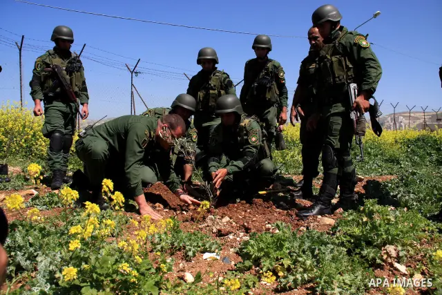 Palestinian security officers plant trees during an event marking Land Day, near the West Bank city of Nablus, Wednesday, March 30, 2011. Land Day commemorates the killing of six Arab citizens of Israel by the Israelis o...