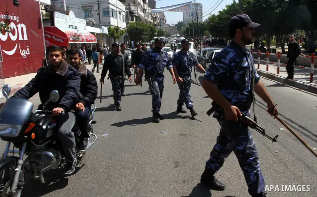 Palestinian Hamas security patrol in a street as Palestinian demonstrators take part in a protest calling for political unity between Gaza's Hamas rulers and the Fatah-dominated Palestinian Authority based in the West Ba...