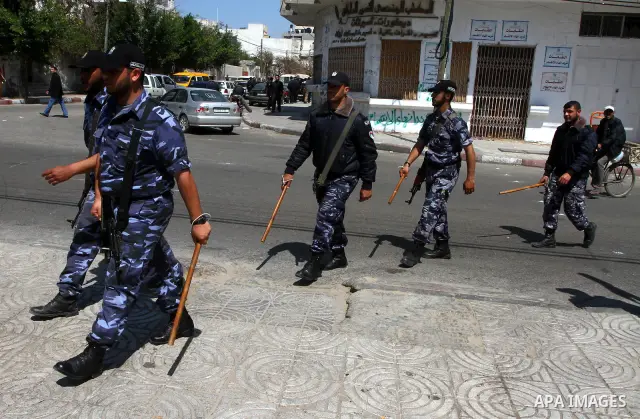 Palestinian Hamas security patrol in a street as Palestinian demonstrators take part in a protest calling for political unity between Gaza's Hamas rulers and the Fatah-dominated Palestinian Authority based in the West Ba...