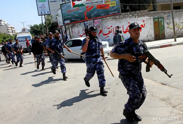 Palestinian Hamas security patrol in a street as Palestinian demonstrators take part in a protest calling for political unity between Gaza's Hamas rulers and the Fatah-dominated Palestinian Authority based in the West Ba...
