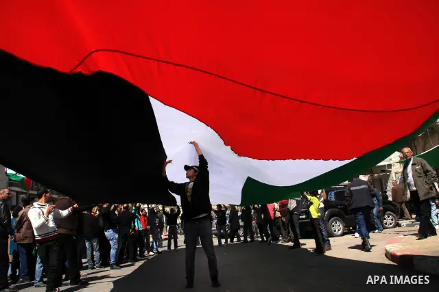Palestinian demonstrators hold flags during a rally marking Land Day in the West Bank city of Nablus, Wednesday, March 30, 2011. Land Day commemorates the killing of six Arab citizens of Israel by the Israelis on March 3...