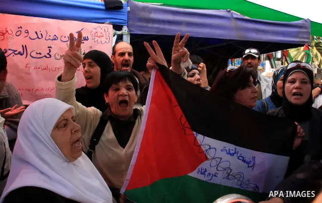Palestinian demonstrators hold flags during a rally marking Land Day in the West Bank city of Nablus, Wednesday, March 30, 2011. Land Day commemorates the killing of six Arab citizens of Israel by the Israelis on March 3...