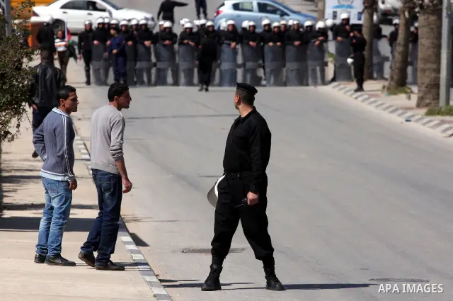 Palestinians anti-riot Police block the road to prevent Palestinian protesters, marking the 35th anniversary of the Land Day, to reach the Israeli checkpoint of Biet El north of Ramallah, 30 March 2011. The rallies kicke...