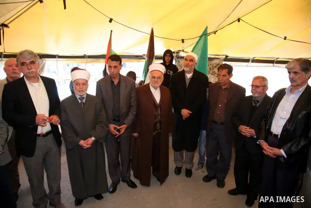 Sheikh Raed Salah and other Palestinians plant olive trees in Silwan, in East Jerusalem to mark the Land Day on March 30,2011, as hundreds of people across Israel and Palestinian territories were holding a series of rall...
