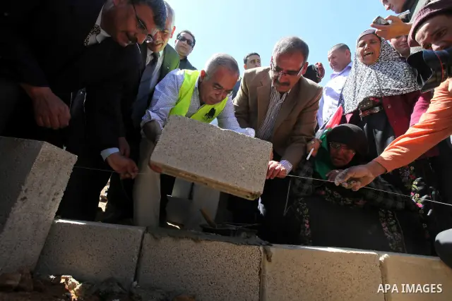 Palestinian prime minister Salam Fayyad visits the southern town of Yatta, near Hebron in the occupied West Bank, on March 30, 2011, as hundreds of people across Israel and Palestinian territories were holding a series o...