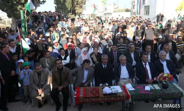 Palestinian prime minister Salam Fayyad plants olive trees in al-Magher village near Ramallah in the occupied West Bank, on March 30, 2011, as hundreds of people across Israel and Palestinian territories were holding a s...