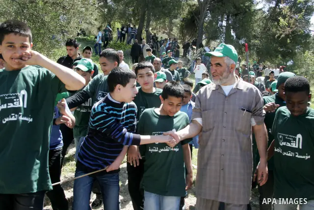 Sheikh Raed Salah and other Palestinians plant olive trees at the Mount of Olives, in East Jerusalem to mark the Land Day on March 30,2011, as hundreds of people across Israel and Palestinian territories were holding a s...