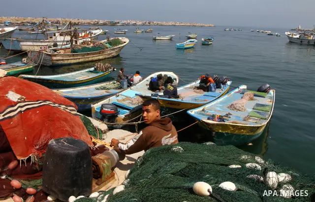 Palestinian fisherman fixes his fishing nets at the port in Gaza City 30, 2011. Israel is considering building an artificial island with sea and air ports off blockaded Gaza, as a long-term solution to shipping goods int...