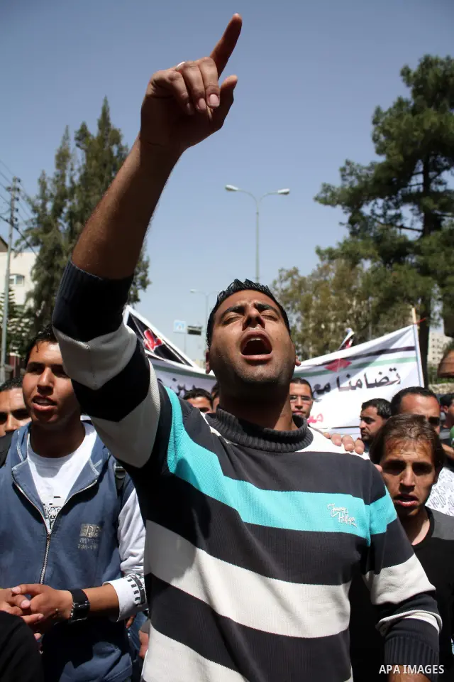 Palestinian protesters take part in a march in solidarity with Palestinian prisoners in Israeli jails and calling for end the split between the two rival leading Palestinian factions Fatah and Hamas, in the West Bank cit...