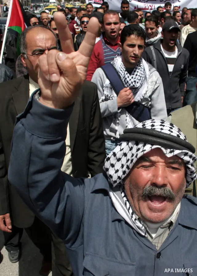 Palestinian protesters take part in a march in solidarity with Palestinian prisoners in Israeli jails and calling for end the split between the two rival leading Palestinian factions Fatah and Hamas, in the West Bank cit...