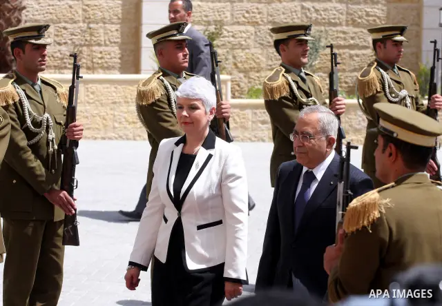 Palestinian Prime Minister Salam Fayyad reviews honor guards with the Croatian counterpart Jadranka Kosor upon her arrival to the West Bank city of Ramallah, on March 31,2011. Photo by Issam Rimawi