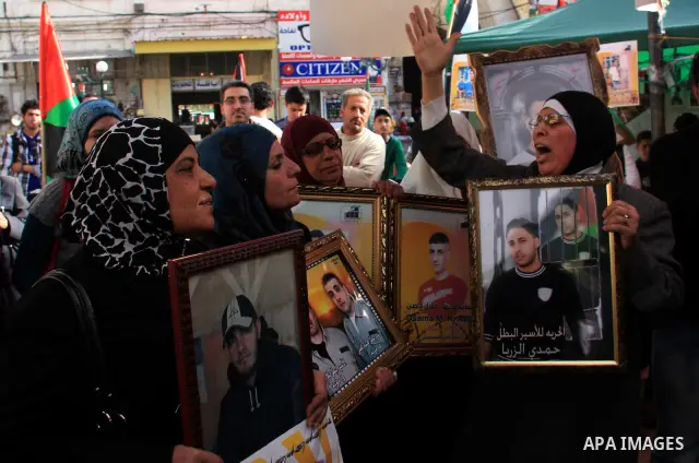 Palestinians women hold portraits of relatives, during a protest calling for the release of Palestinian prisoners from Israeli jails, in the West Bank city of Nablus , Thursday, March 31, 2011. Israel currently holds abo...