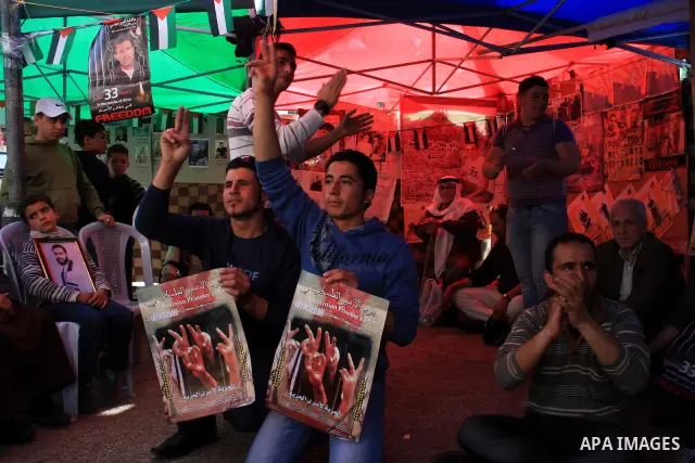 Palestinians men hold portraits of relatives, during a protest calling for the release of Palestinian prisoners from Israeli jails, in the West Bank city of Nablus , Thursday, March 31, 2011. Israel currently holds about...