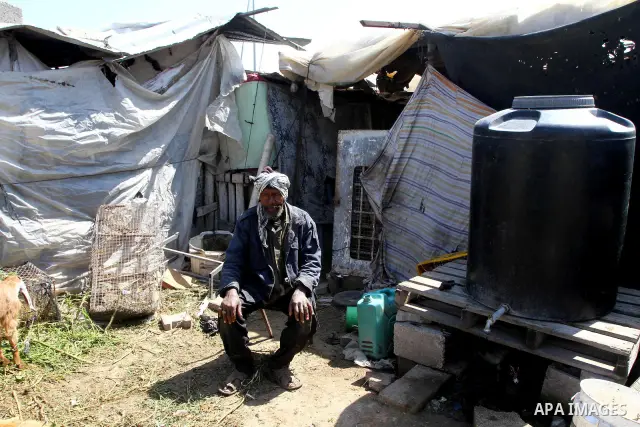 A Palestinian old man stands at his miserable tent in one of the most poor regions in the Gaza Strip on March,31, 2011. Photo by Ashraf Amra