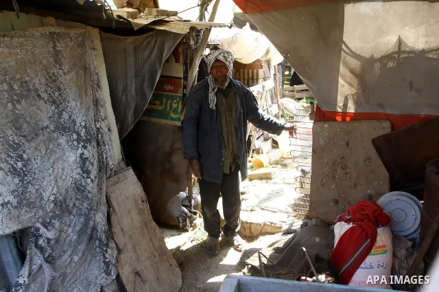 A Palestinian old man stands at his miserable tent in one of the most poor regions in the Gaza Strip on March,31, 2011. Photo by Ashraf Amra