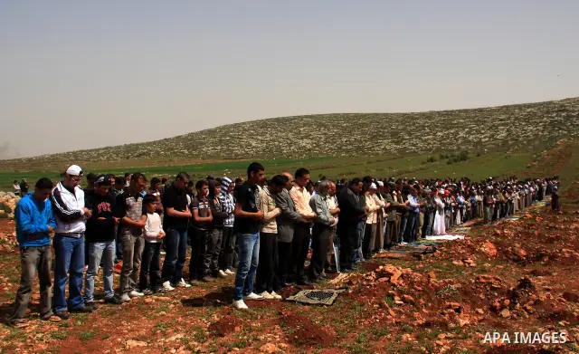 Palestinians perform Friday prayers on an open field in the village of Qusra, near the Jewish settlement of Shilo, in the Israeli-occupied West Bank, on April 1, 2011. Photo by Wagdi Eshtayah