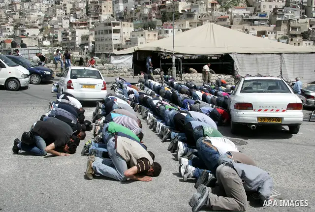 Palestinians attend Friday prayers at the protest tent in the Silwan neighborhood in East Jerusalem on 01 April 2011 as Palestinian protesters gather for a demonstration. A few stones were thrown and a few rounds of tear...