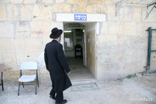 An Orthodox Jewish walks outside a part of a mosque in the Village of the Prophet Samuel, which has been converted into a Jewish synagogue on April 1,2011. Photo by Sliman Khader.