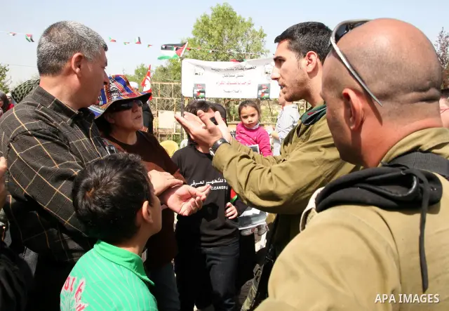 Israel soldiers prevent Sheikh Raed Salah and other Palestinians from planting olive trees in the Village of the Prophet Samuel, near Jerusalem on April 1,2011. Photo by Sliman Khader..