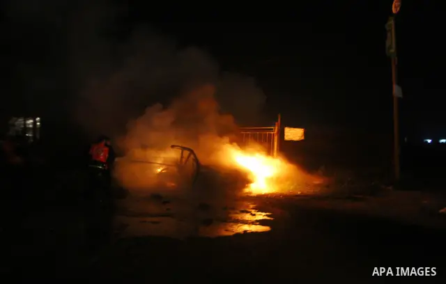 Members of civil defence try to stop fire in a car after an Israeli air strike in Deir Al-Balah in the central Gaza Strip early April 2, 2011. Israeli aircraft killed three Palestinian gunmen in the southern Gaza Strip e...