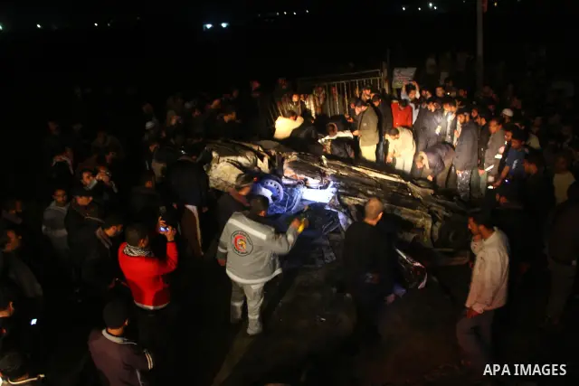 Members of Hamas' security forces inspect a car after an Israeli air strike in Deir Al-Balah in the central Gaza Strip early April 2, 2011. Israeli aircraft killed three Palestinian gunmen in the southern Gaza Strip earl...