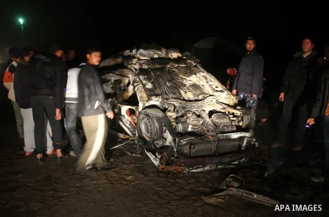 Palestinian Hamas officers inspect a vehicle following an Israeli airstrike that killed three of Hamas militants near Deir Al Balah, central Gaza Strip, early Saturday, April 2, 2011. Israeli aircraft killed the militant...