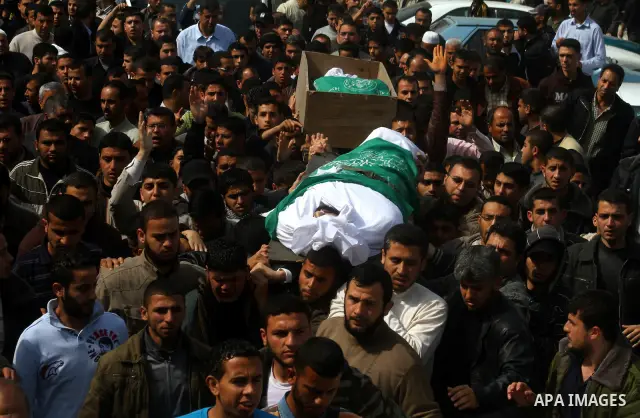 Palestinians carry the bodies of Hamas militants Ismail Lubbad and Abdallah Lubbad, two brothers killed earlier in an Israeli airstrike, during their funeral in Shati refugee camp in Gaza City, Saturday, April 2, 2011. I...