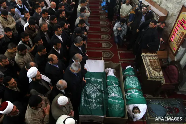 Palestinians pray next to the bodies of Hamas militants in Al-Omari Mosque during their funeral in Gaza City April 2, 2011. Israeli aircraft killed three Palestinian gunmen in the southern Gaza Strip early on Saturday, m...