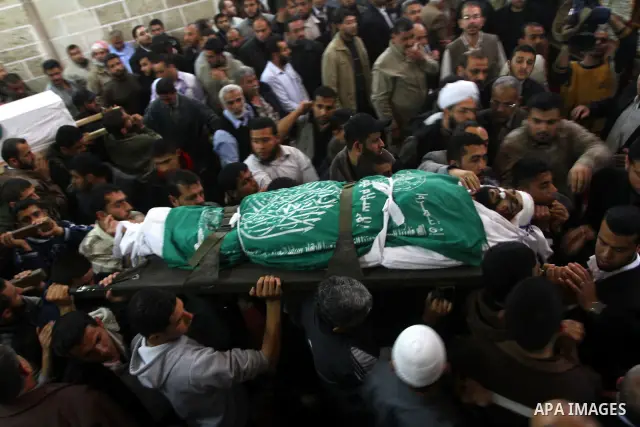 Palestinians carry the bodies of Hamas militants in Al-Omari Mosque during their funeral in Gaza City April 2, 2011. Israeli aircraft killed three Palestinian gunmen in the southern Gaza Strip early on Saturday, medical...