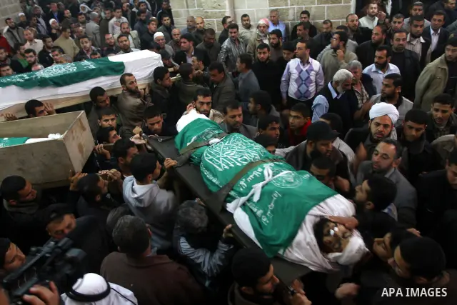 Palestinians carry the bodies of Hamas militants in Al-Omari Mosque during their funeral in Gaza City April 2, 2011. Israeli aircraft killed three Palestinian gunmen in the southern Gaza Strip early on Saturday, medical...