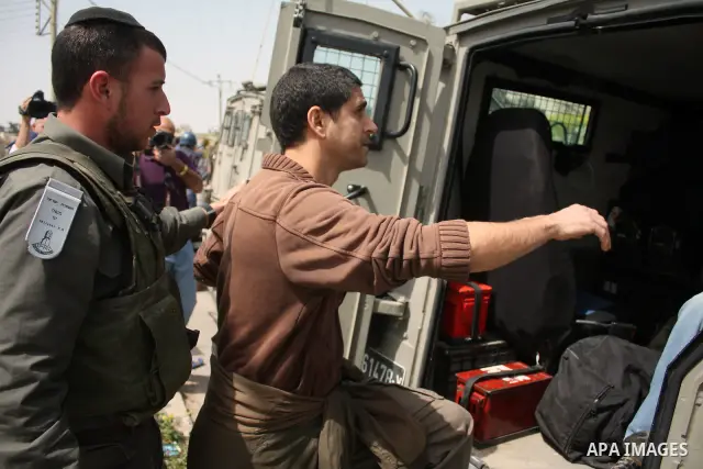 Israeli soldiers detain a demonstrator during a protest by foreign, Israeli and Palestinian demonstrators against the controversial Israeli separation barrier, in the Palestinian village of Beit Omar, near the West Bank...