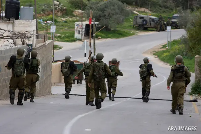 Israeli border police officers walk out of Palestinian houses during clashes at a protest against the expansion of the nearby Jewish settlement of Halamish in the West Bank village of Nabi Saleh near Ramallah, Saturday,...