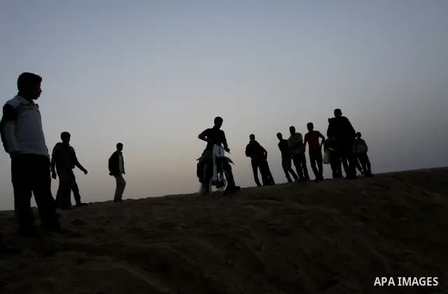 A Palestinian man rides his motorcycle on sand dunes during the weekly sport event in the Gaza Strip town of al-Zahra, south of Gaza City, on April 1,2011. Palestinian youths use the dunes for riding their motorcycles, h...