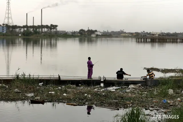 Egyptian men stand at the edge of the Nile River in Cairo, Egypt, Sunday on April 3, 2011. Photo by Wissam Nassar