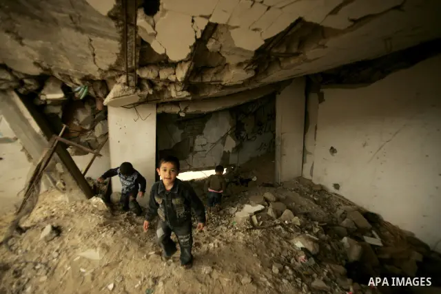 Palestinian children play on a destroyed building in Rafah, damaged during the 22-day Israeli offensive on the Gaza Strip, on April 4, 2011, a day after Israel demanded that the United Nations bin a report critical of it...